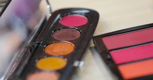 Dipping brush in eye shadows, decorative cosmetics for makeup closeup - Кадри, відео