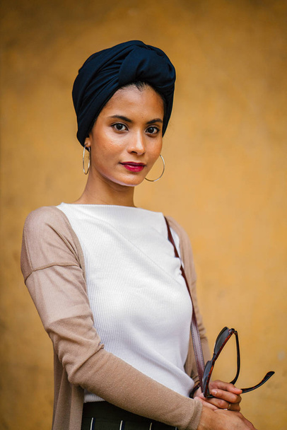 Portrait of a young Muslim woman (Islam) wearing a turban (headscarf, hijab). She is elegant, attractive and professionally dressed. - Foto, immagini