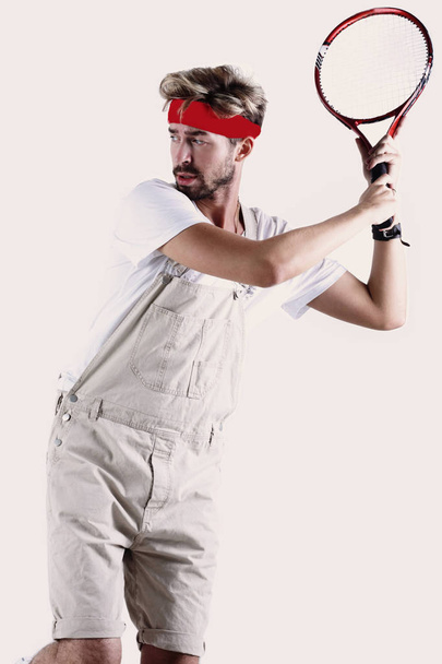 Male tennis player with racket in action. - Fotó, kép