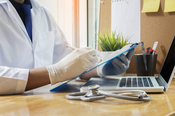 Stethoscope with clipboard and Laptop on desk,Doctor working in  - Photo, Image