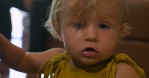Close up portrait of young cute toddler baby with drool on chin - Video