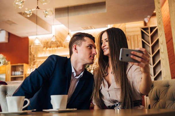 Happy young couple taking selfie with smart phone at cafe - Φωτογραφία, εικόνα