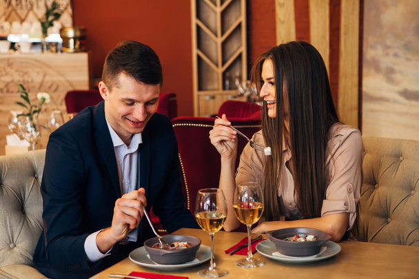 Dating concept, couple drinking wine in a restaurant - Фото, зображення