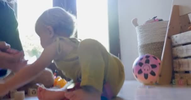 Authentic moment with a baby crawling closer to its father - Video