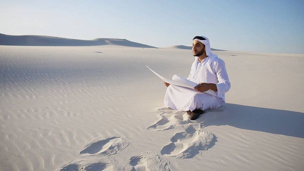 Enterprising male sheikh businessman sitting with white paper in - Photo, Image