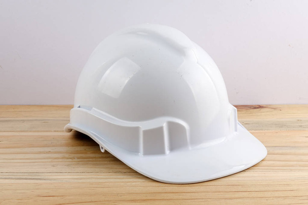 HEALTH AND SAFETY CONCEPT. Personal protective equipment on wooden table over white background. - Photo, Image