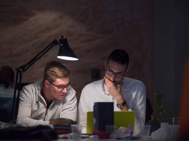 young designers working on a new project in the night startup office using modern technology - Foto, Imagem