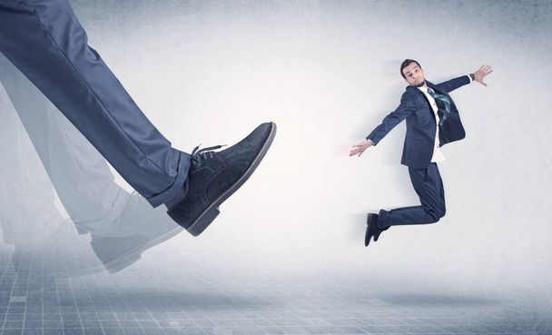 Businessman foot kicking small businessman - Фото, изображение