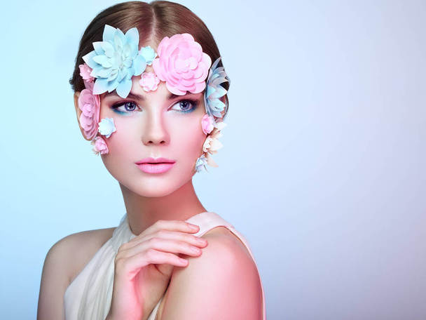 Face of beautiful woman decorated with flowers - 写真・画像