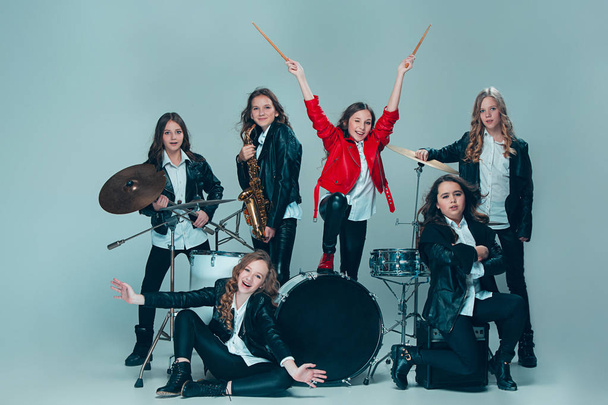 The teen music band performing in a recording studio - Фото, изображение