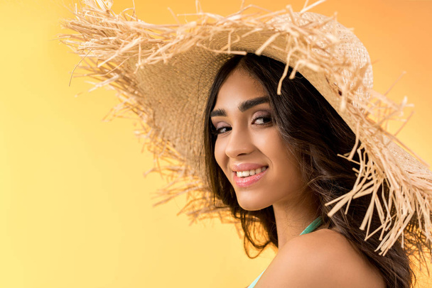portrait of attractive girl posing in straw hat, isolated on yellow - Fotoğraf, Görsel