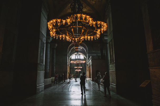 ISTANBUL, TURKEY - OCTOBER 09, 2015: tourists walking under chandelier in suleymaniye mosque - Zdjęcie, obraz