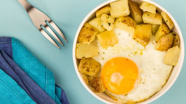 Жареное яйцо с жареной картошкой в миске
 - Фото, изображение