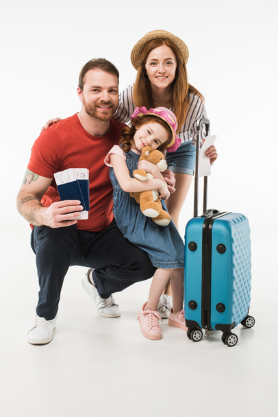 Portrait of happy family of tourists with suitcase isolated on white - Fotografie, Obrázek