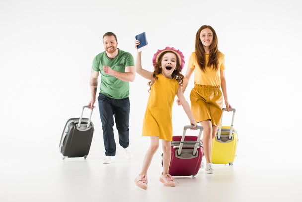 Happy running family with suitcases isolated on white, travel concept - Fotografie, Obrázek