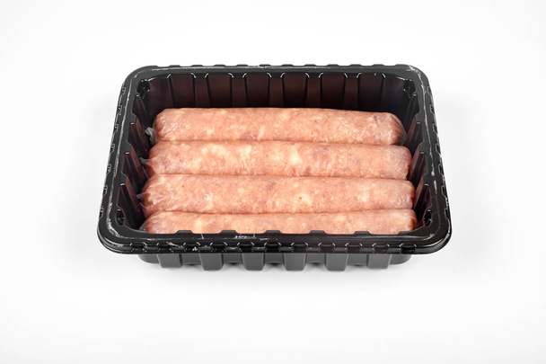 Package of raw sausages isolated on white background - Фото, изображение