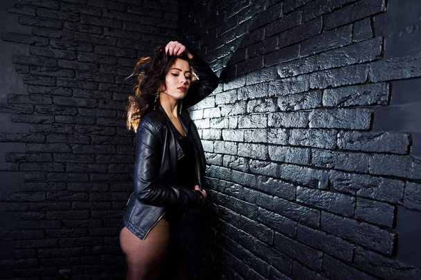 Studio portrait of sexy brunette girl in black leather jacket ag - Photo, Image