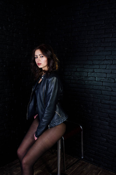 Studio portrait of sexy brunette girl in black leather jacket ag - Фото, зображення