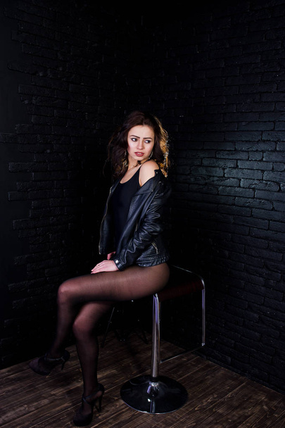 Studio portrait of sexy brunette girl in black leather jacket ag - Fotoğraf, Görsel