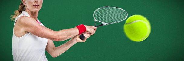 Athlete playing tennis with a racket  against green background - Foto, immagini