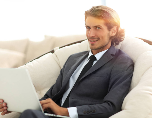 close-up of smiling businesswoman working with laptop in living  - Фото, зображення
