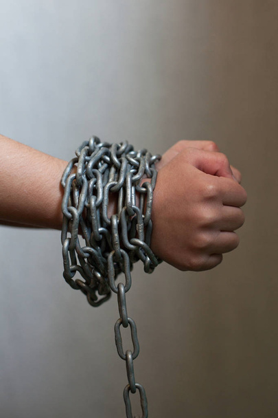 Kid's hands tied with chain. - Фото, изображение