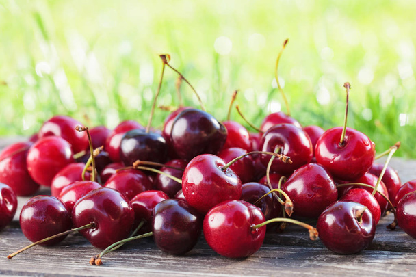 Juicy sweet cherries on wooden table. - Photo, Image