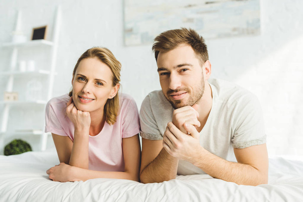 Portrait of young caucasian couple in bed  - Фото, изображение