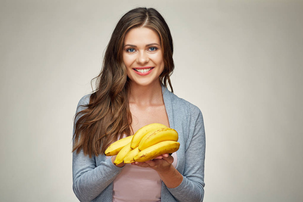 portrait of smiling woman holding ripe bananas, diet concept  - Photo, Image