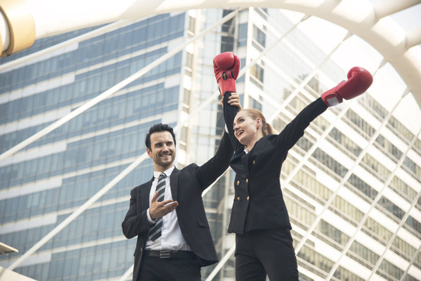 happy businesswoman with boxing gloves on arms raised in victory - Photo, Image