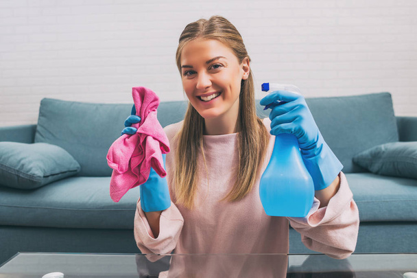 Beautiful woman enjoys cleaning house.Image is intentionally toned. - Valokuva, kuva