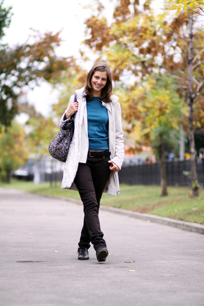 Full length, walking woman in autumn park - Photo, image