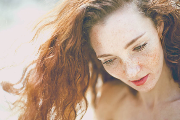 portrait, beautiful freckled young adult girl with red hair looking  down.  - Fotografie, Obrázek