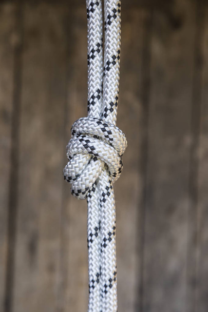 Rope knot on a teak wood background. - Photo, Image