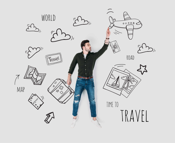 creative hand drawn collage with man and various travel signs - Photo, Image