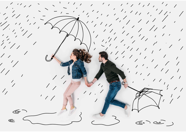 creative hand drawn collage with couple running under rain with umbrellas - Photo, Image