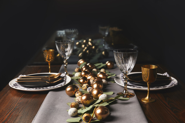 restaurant table with easter decoration and golden eggs - Fotoğraf, Görsel