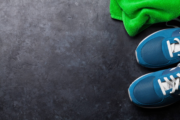 Fitness concept background with sneakers and towel. Top view with space for your text - Photo, Image