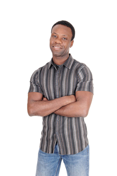Handsome African man smiling arms crossed - Photo, image