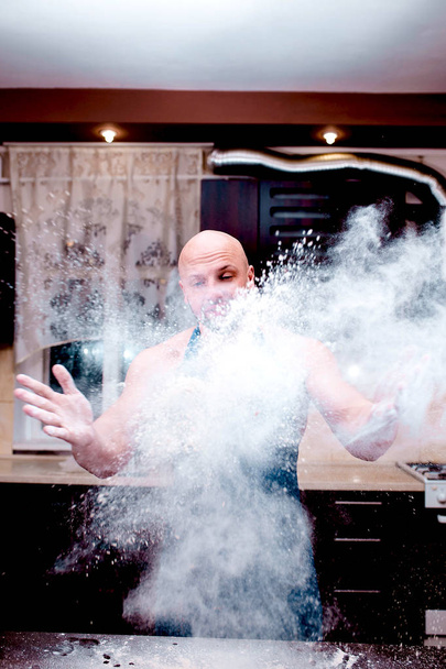 A young man chefs throw flour - Photo, Image
