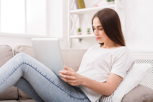 Young girl with laptop on the sofa - Photo, Image