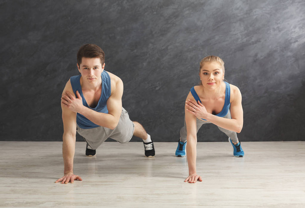 Couple making plank or push ups exercise indoors - Photo, Image