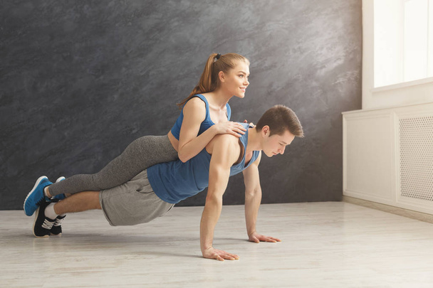 Couple making plank or push ups exercise indoors - Foto, Imagen