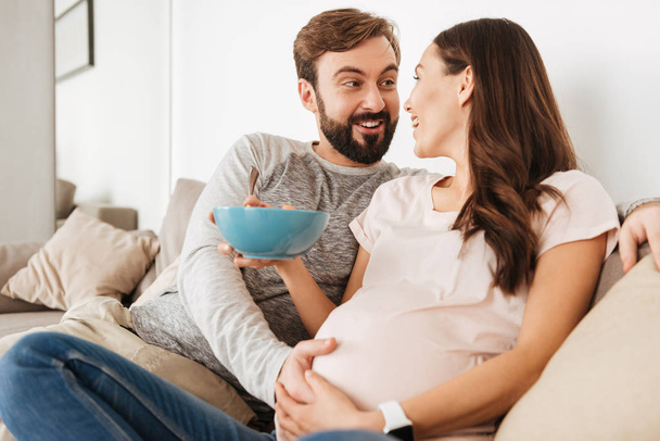 Laughing young pregnant couple - 写真・画像
