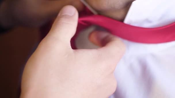 man dresses for work morning. man ties up red tie - Footage, Video
