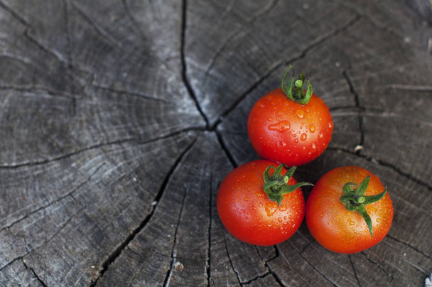 Fresh wet red tomatoes on a wooden background - Photo, Image