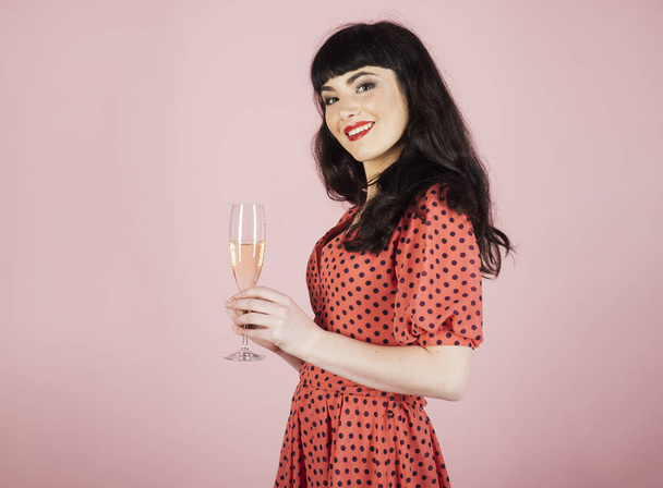 Woman drinks champagne and smiles. - 写真・画像