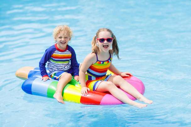 Kids on inflatable float in swimming pool.  - Photo, Image