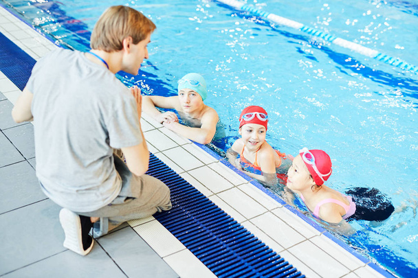 Pływać trener wyjaśniając jego uczniów w basenie, co robić dalej - Zdjęcie, obraz