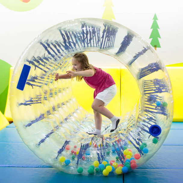 Child play in roller wheel. Kids on trampoline.  - Photo, Image